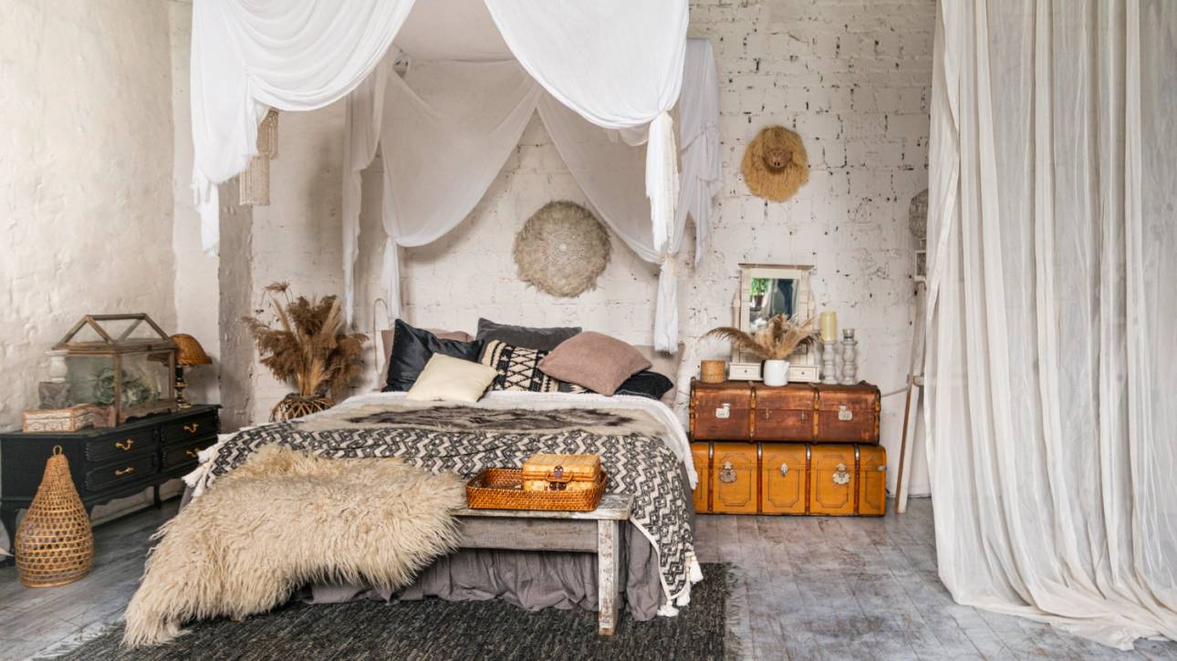 A stylish bedroom showcasing a canopy bed and a plush rug, creating a warm and inviting atmosphere